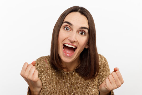 Cheerful happy young beautiful girl looking at camera smiling laughing over white background.