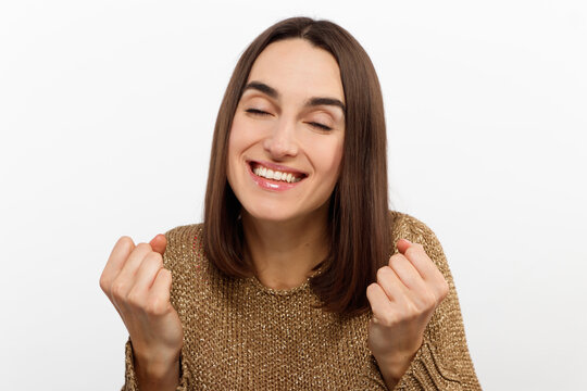 Cheerful happy young beautiful girl looking at camera smiling laughing over white background.