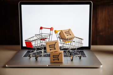 Boxes in a trollies on a laptop keyboard. Online shopping concept.