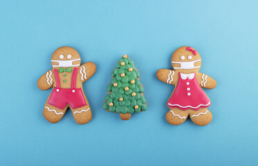 gingerbread man in a ginger cookie face mask iced sugar decoration on a blue background