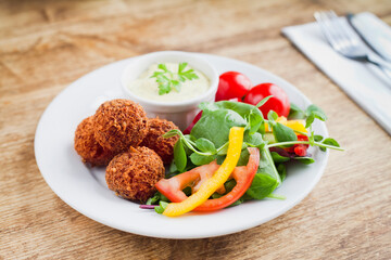 Vegan mushrooms balls -  deep-fried falafel starter. The healthy takeaway, alternative fast food.
