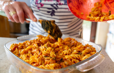 Chicken and ham pasta bake being prepared