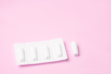 Background Candles for anal or vaginal use on a pink light background of the medication.
