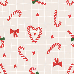 Seamless pattern of christmas red striped candies, red and green bows and red hearts in traditional christmas color. Hand drawn illustration in doodle style. For greeting card and another print design