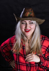 Attractive plump woman dressed in cow boy style