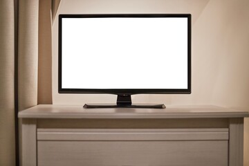 Small LCD TV, in a dim room, blank white copy space on the screen