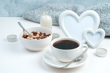 Cereal balls and a Cup of chicory on a romantic background with hearts. Side view with space for copying. Concept of holiday backgrounds.