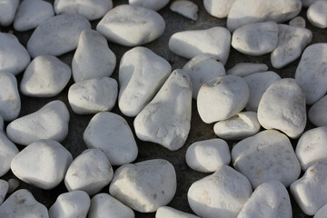 white stones lie on the asphalt