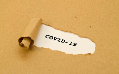 Covid-19 written under torn paper.