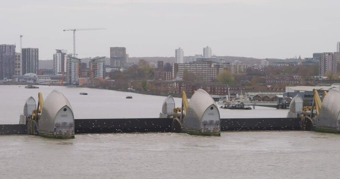 Aerial view from Royal Wharf development towards Thames barrier fully closed. Located on the River Thames in East London. Capturing elevated, aerial view looking towards South East London