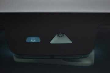 Rain and light sensor on the windshield of the car