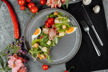 caesar salad on a gray plate with decor and copyspace
