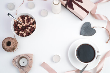 Chocolate balls and coffee on a festive light background. The view from the top. The concept of Valentine's day.
