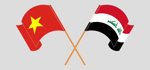 Crossed and waving flags of Vietnam and Iraq