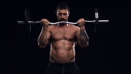 Fit and sporty bodybuilder over black background. Sportsman in studio. Sport and fitness concepts.