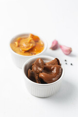 Ceramic bowls with canned mushrooms. Fermented food on a white background