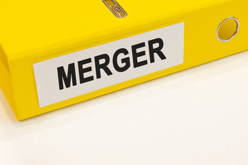The word merger on a white background with a yellow folder. Business concept