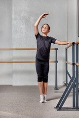 Beautiful slender man dancing ballet. Basic positions in ballet. Vertical image. © Evgenia