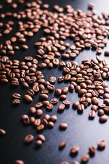 scattered coffee beans on a dark background