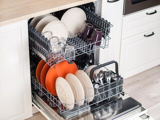 dishwasher close-up with washed dishes, easy to use and save water, eco-friendly, built-in kitchen...