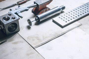 Jewelry tools. Jewellery. Goldsmith workplace, workspace on light background. Hand craft. Workshop. Manufacturing. Closeup. Toned metal background