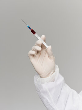 laboratory hand in medical glove vaccine treatment research