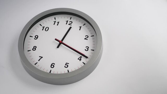Ticking clock on white background, copyspace