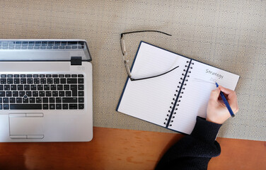 Drafting the strategy for the next year in a notebook