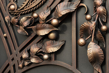 Decorative forged elements, forged abstract leaves on a metal gate