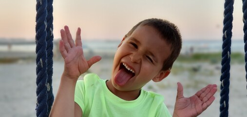 child playing on playground at beach