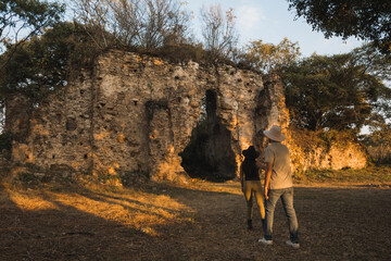Naklejka premium Wedding couple discovering an old destroyed church and food by the vegetation of the jungle
