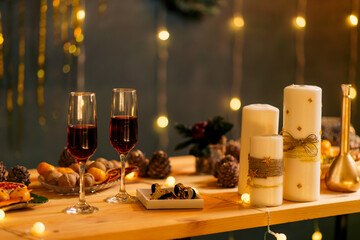 New year table decoration with christmas decor, champagne glasses, festive paraphernalia, side view