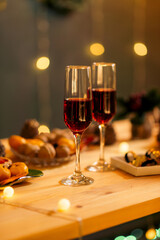 New year table decoration with christmas decor, champagne glasses, festive paraphernalia, side view