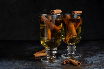 Christmas mulled wine on dark background. Hot alcohol drink cinamon
