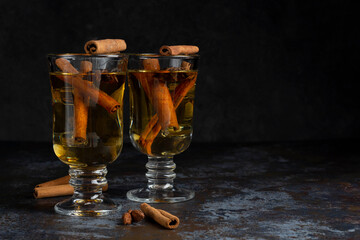 Christmas mulled wine on dark background. Hot alcohol drink cinamon

