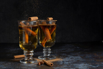 Christmas mulled wine on dark background. Hot alcohol drink cinamon
