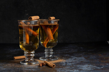 Christmas mulled wine on dark background. Hot alcohol drink cinamon
