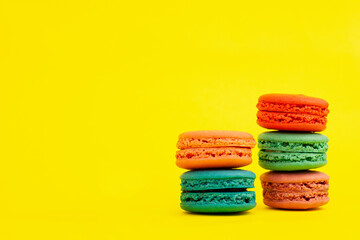 French colorful macarons on a yellow background.Dessert, sweets.