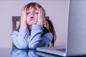Disadvantages of online learning during the coronavirus pandemic. Young dissatisfied girl exhausted...