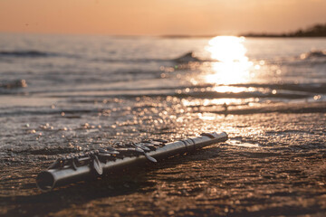 relaxation with an old silver flute on the seaside © olga