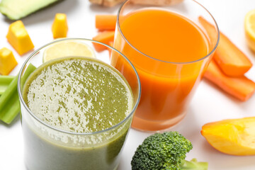 Delicious vegetable juices and fresh ingredients on white background, closeup