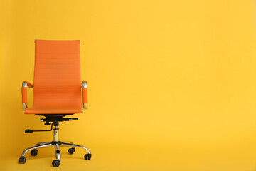 Modern office chair on yellow background. Space for text