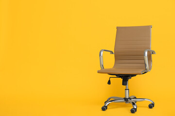 Modern office chair on yellow background. Space for text