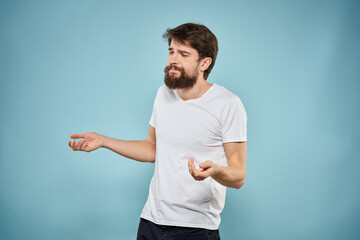 Man in white t-shirt emotions facial expression cropped view studio blue background lifestyle