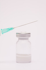 Syringe and vaccine in glass taro, closed isolated on white background