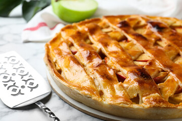 Fresh traditional apple pie on white marble table, closeup