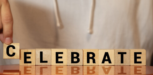 Celebrate word written on wood block. Celebrate text on cement table for your desing, concept.