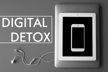 Text Digital detox and devices on grey background, top view
