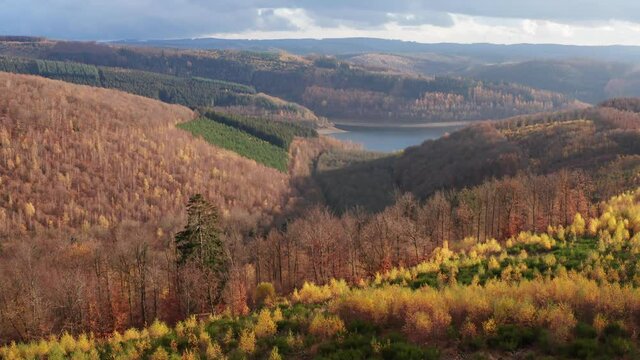 
the obernau reservoir with the rothaar mountains in germany in autumn