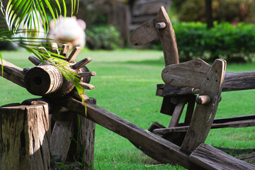 Children's play equipment made of wood are in the garden.